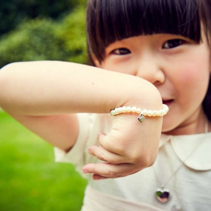 young girl with pearl bracelet