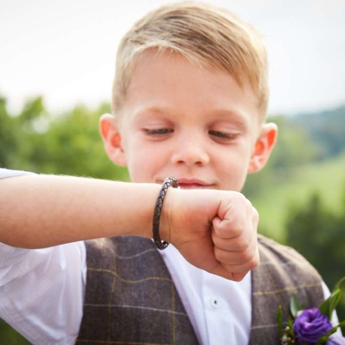 young boy with leather bracelet