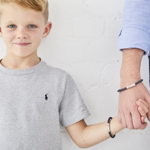 young boy and dad with matching leather bracelets