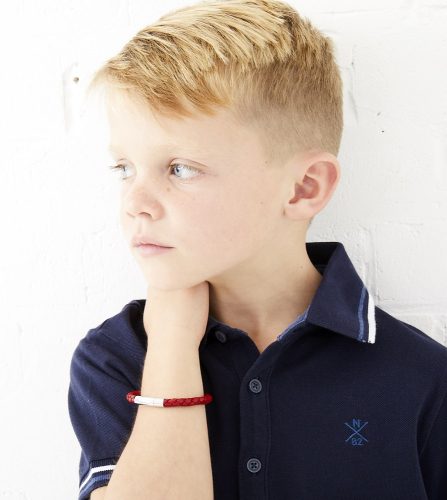 little boy with red leather bracelet