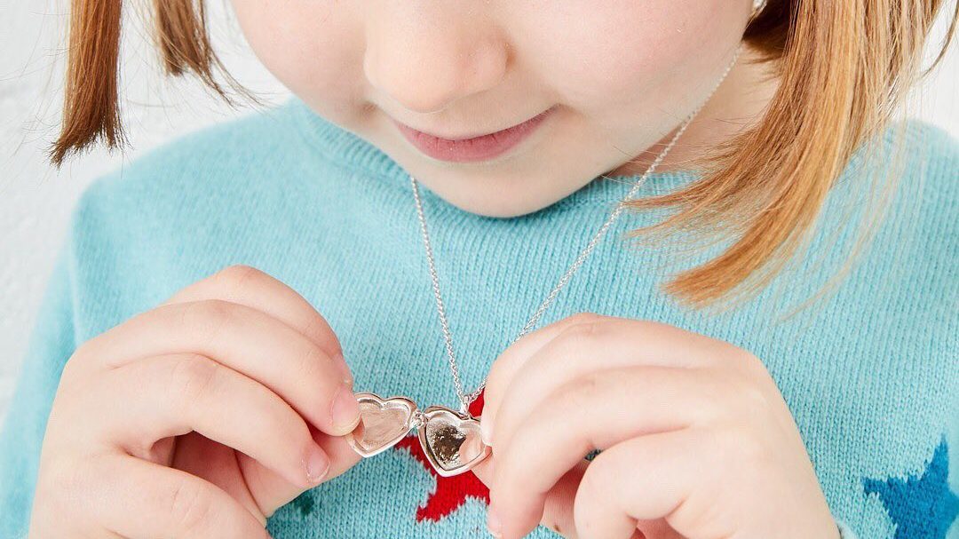 small girl wearing a necklace
